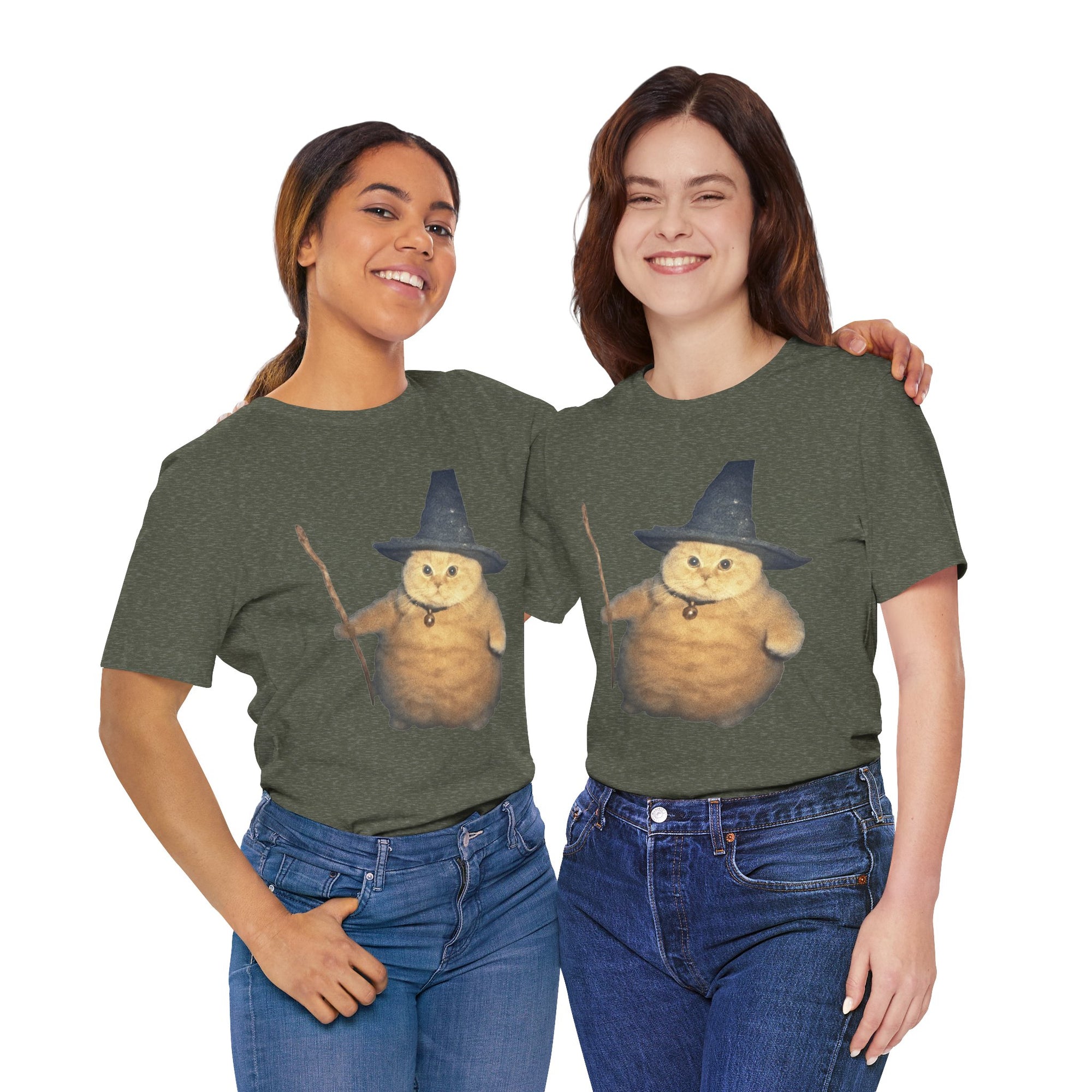 Two women wearing green t-shirts with a cartoon cat in a witch hat design on a white background.