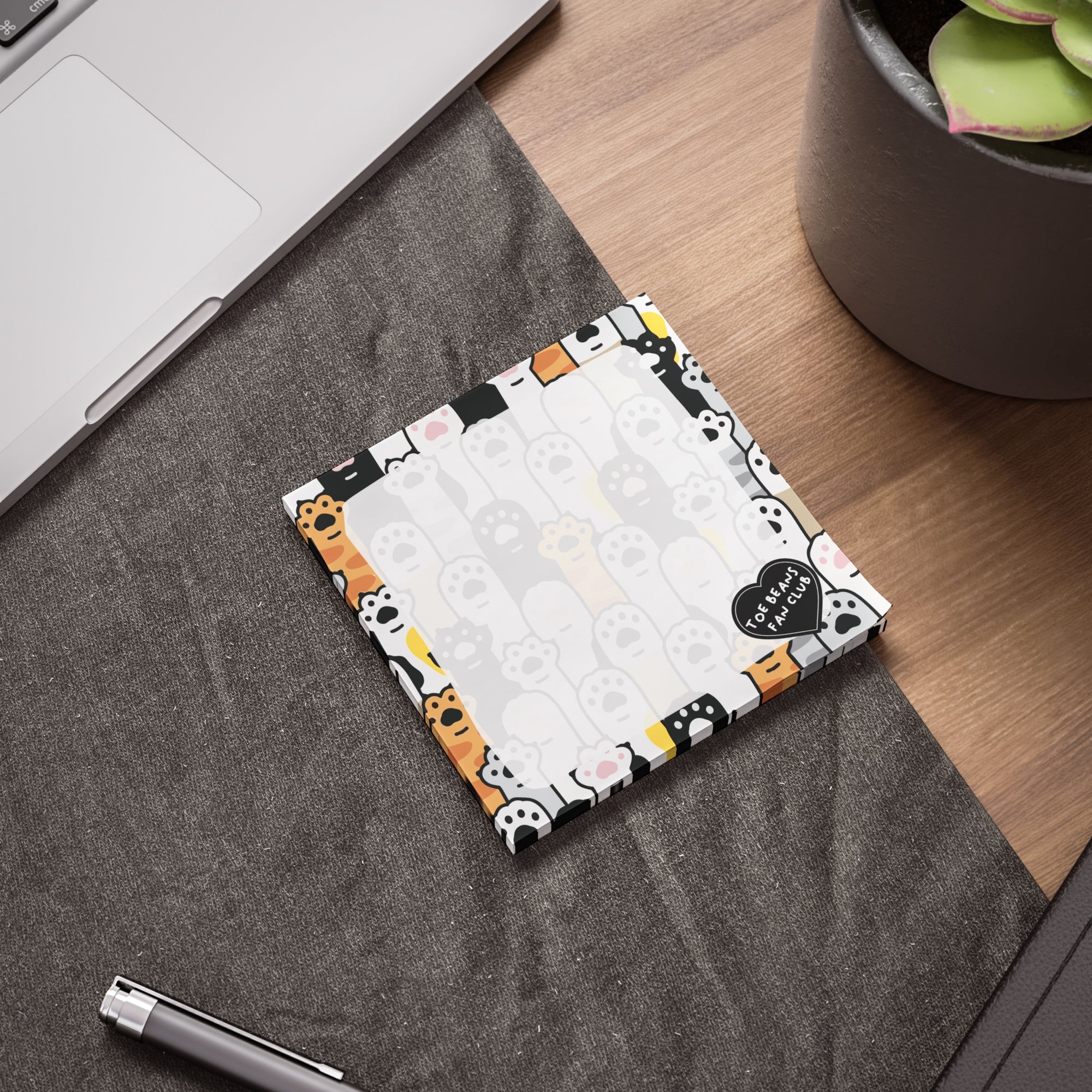 Cute cat-themed sticky note pad with a repeating toe bean and cat paw border, a small “Toe Beans Fan Club” badge, and a lighter center area for writing notes.
