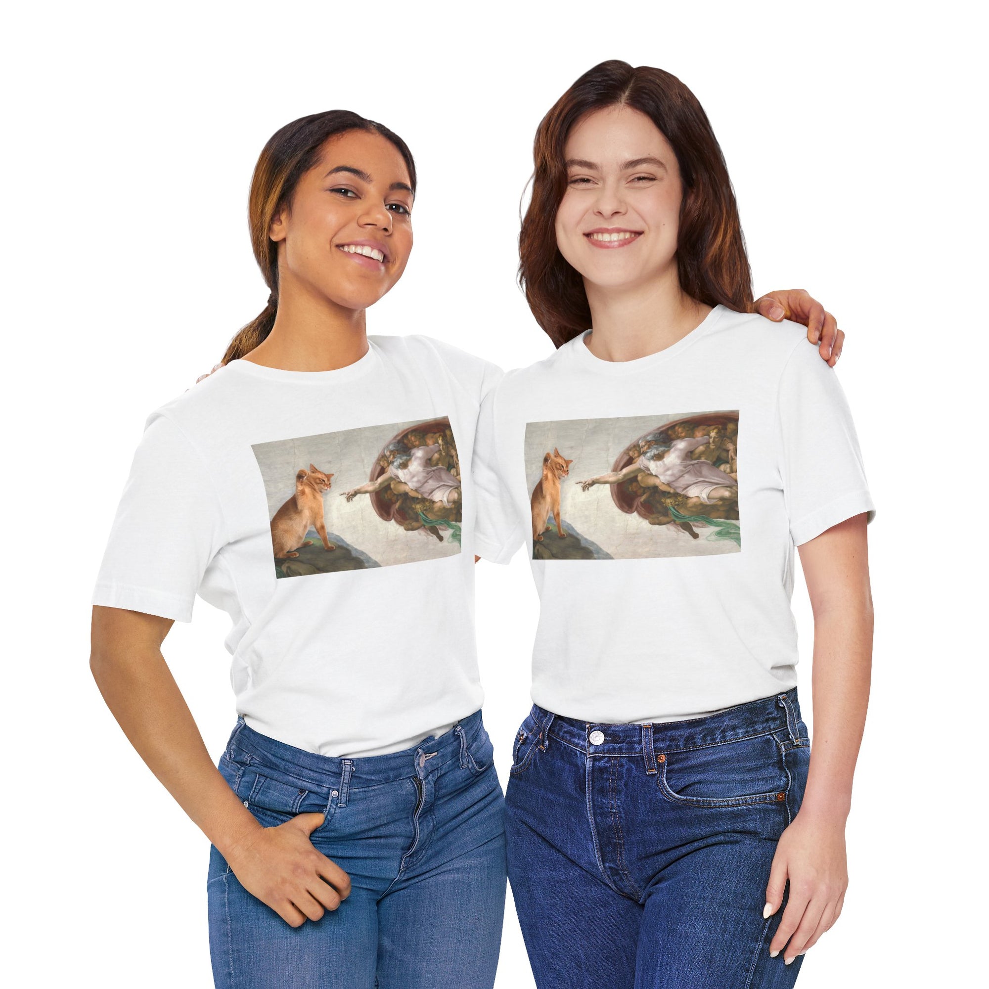Two women wearing white t-shirts with a graphic design of acat and god on a white background.