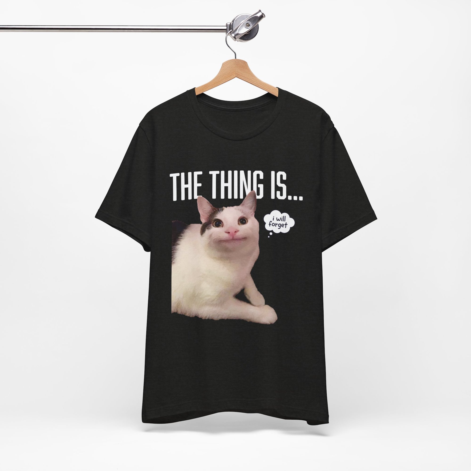Black t-shirt with a cat graphic and text on a hanger against a white background