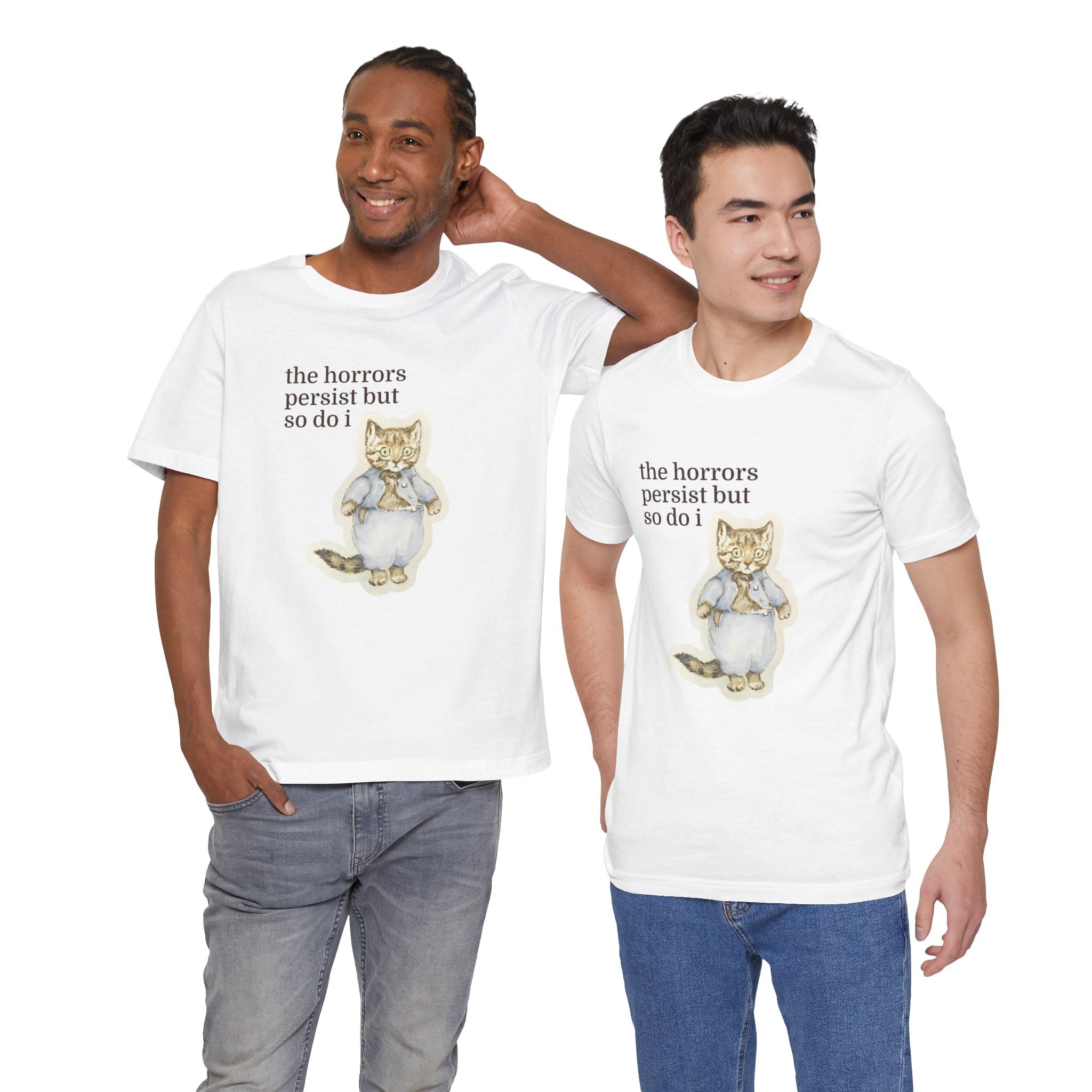Two men wearing white t-shirt featuring a vintage-style illustrated cat in blue clothing with the phrase “the horrors persist but so do i.”