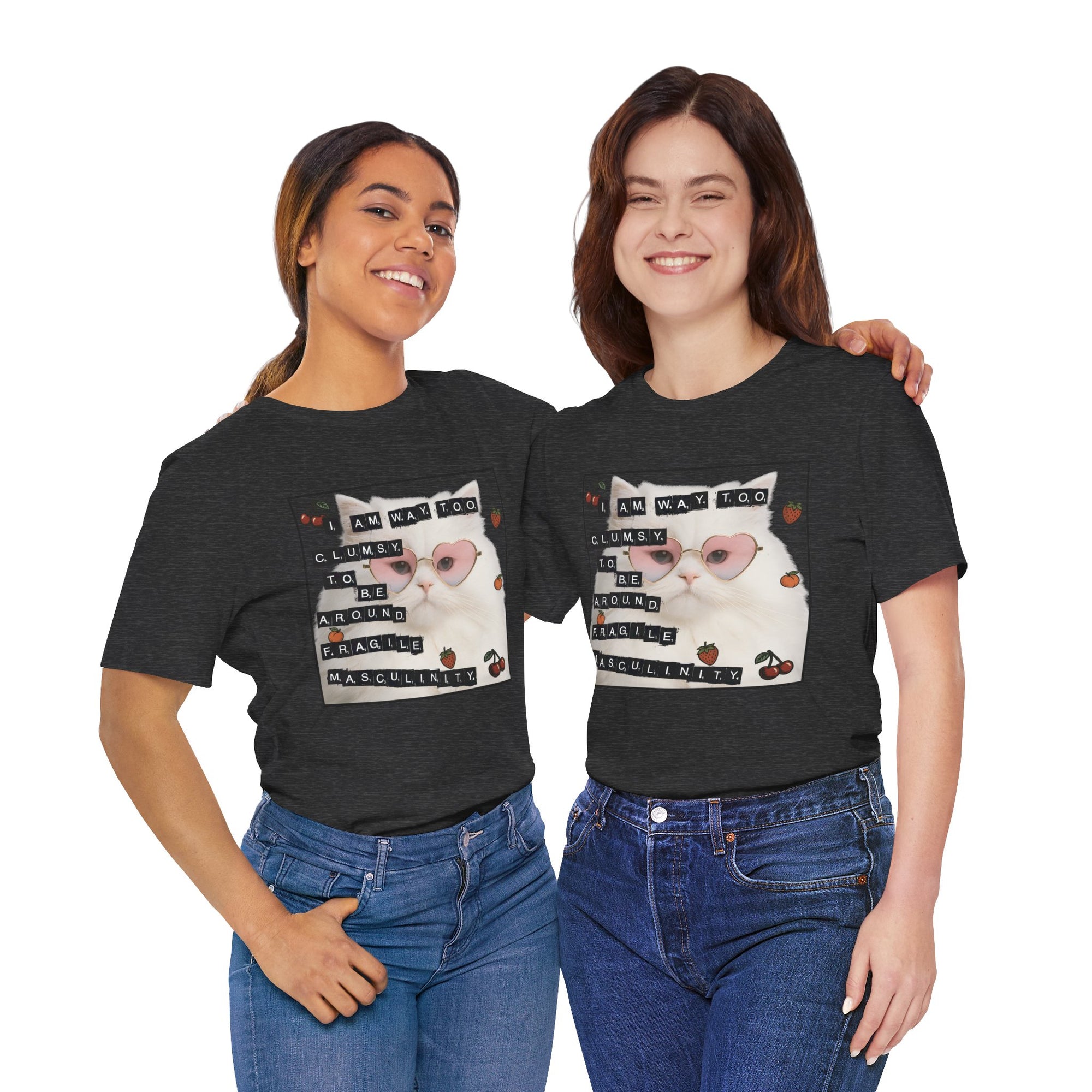 Two people wearing black t-shirt featuring a fluffy white cat in pink heart-shaped sunglasses with ransom-note style text that says “I am way too clumsy to be around fragile masculinity.”