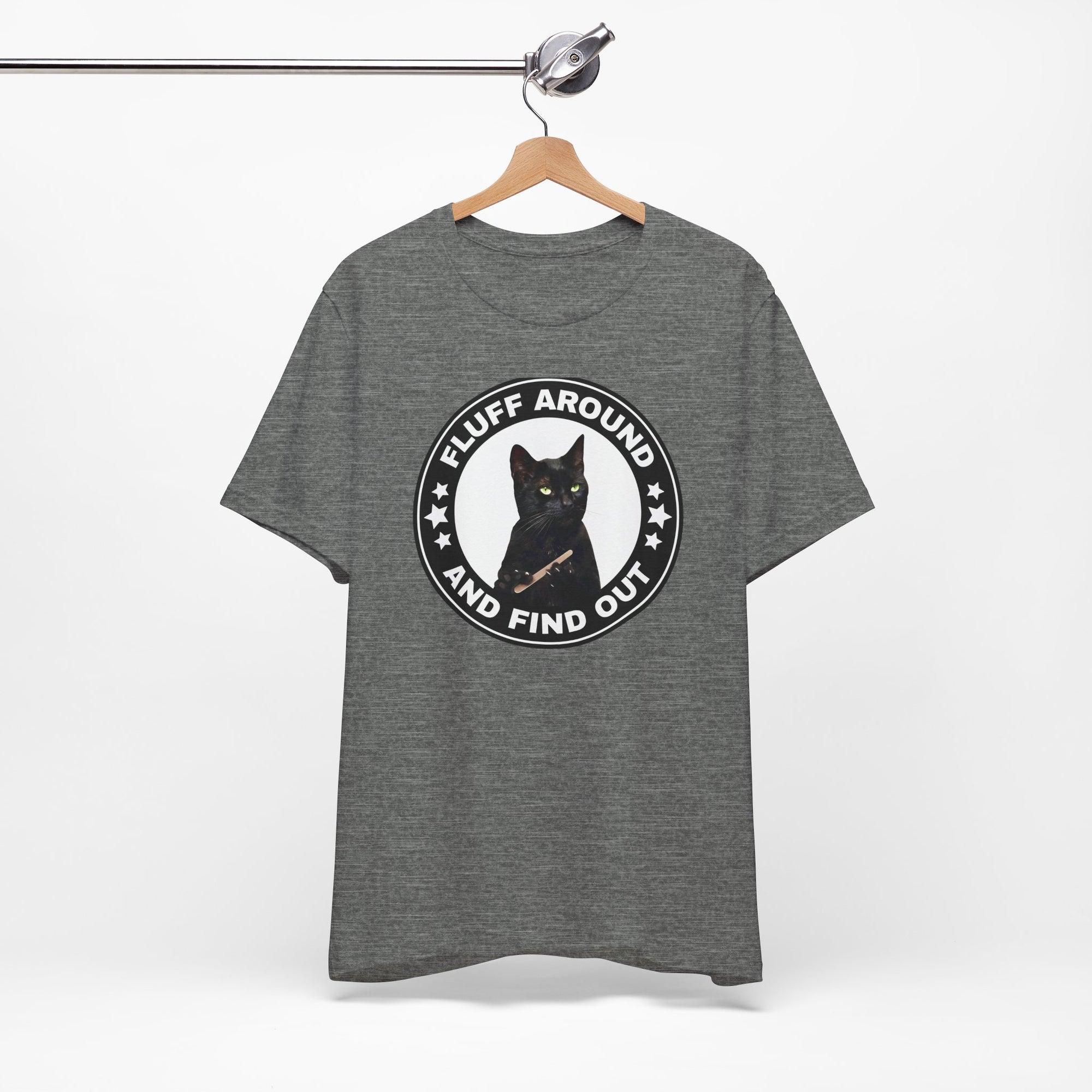 Gray t-shirt featuring a circular badge design with a black cat and the phrase “Fluff Around and Find Out.”
