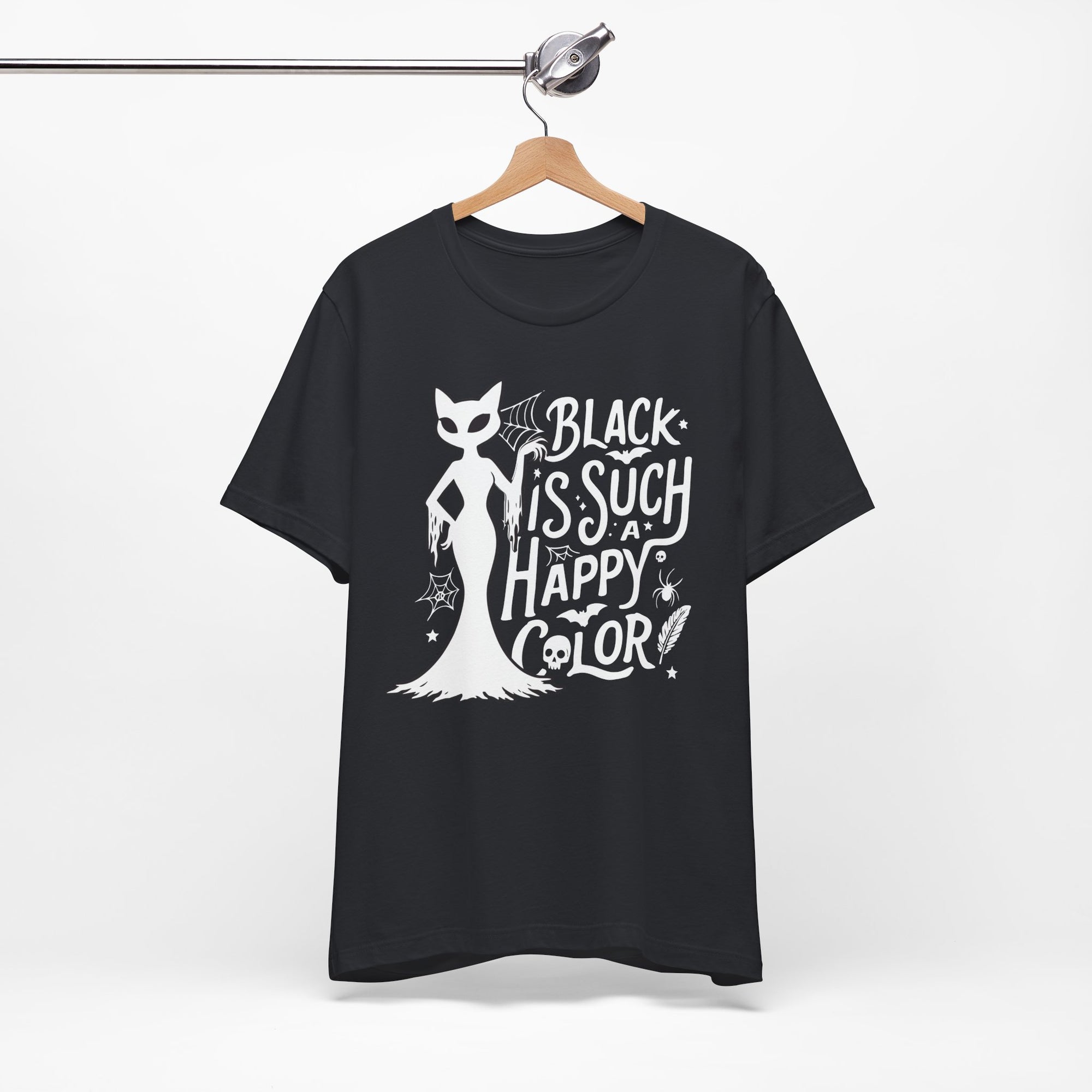 Black t-shirt featuring a white spooky cat graphic with the phrase “Black Is Such a Happy Color,” plus bats, spiderwebs, stars, and Halloween details.
