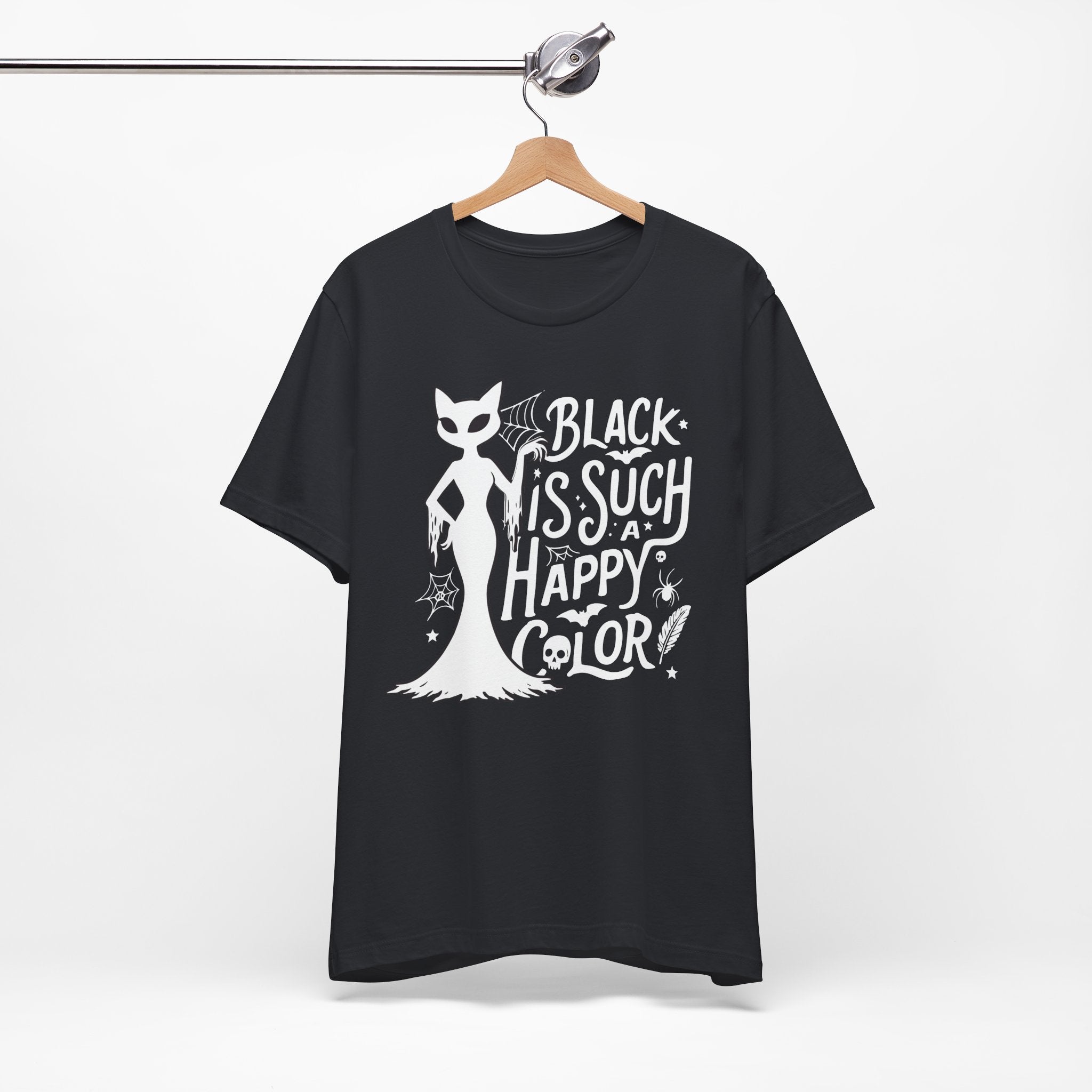 Black t-shirt featuring a white spooky cat graphic with the phrase “Black Is Such a Happy Color,” plus bats, spiderwebs, stars, and Halloween details.
