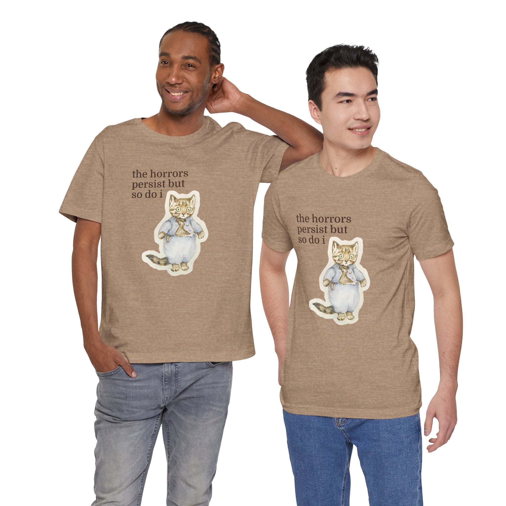Two men wearing matching brown t-shirt featuring a vintage-style illustrated cat in blue clothing with the phrase “the horrors persist but so do i.”