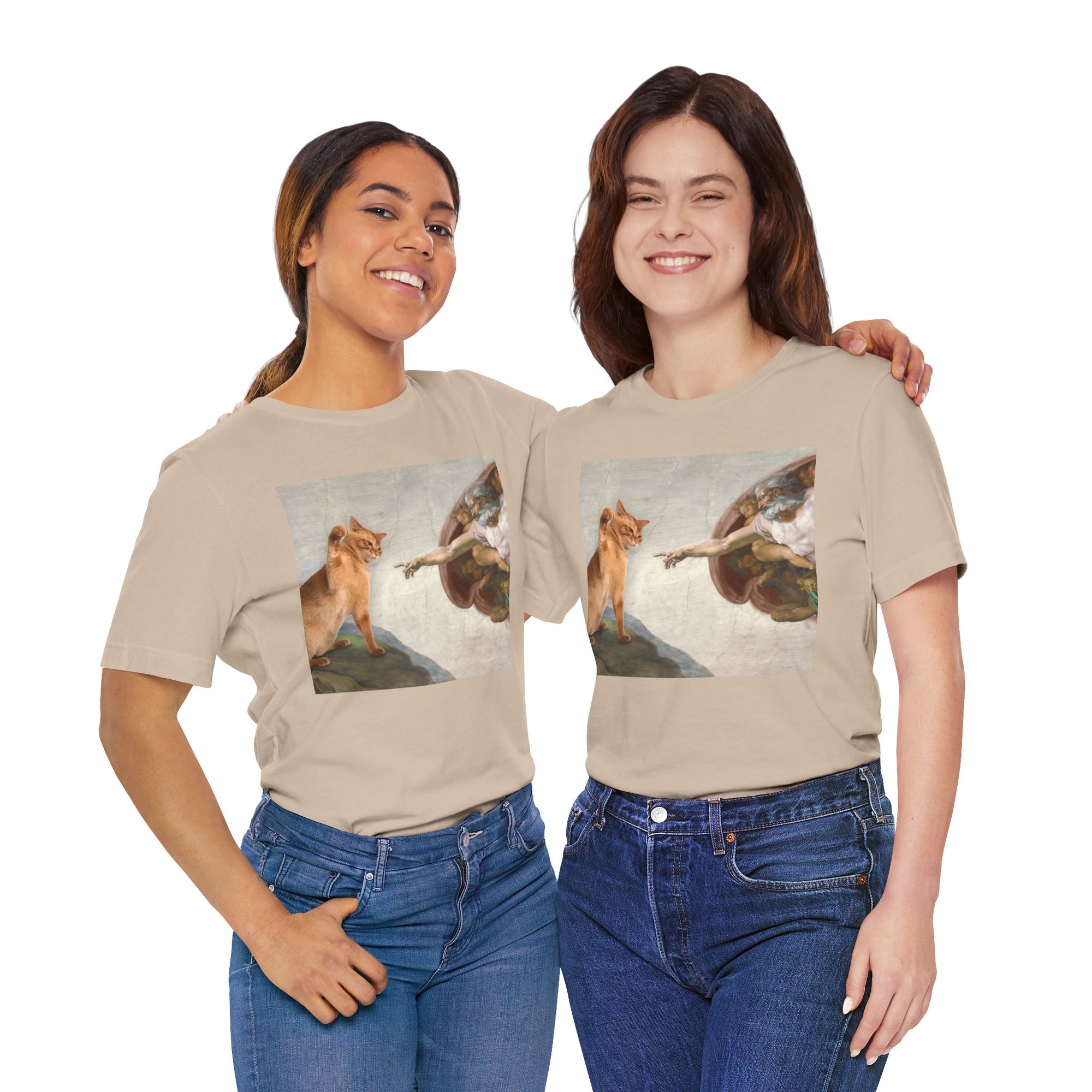 Two people wearing beige t-shirts with artistic designs of a woman and a dog on a white background