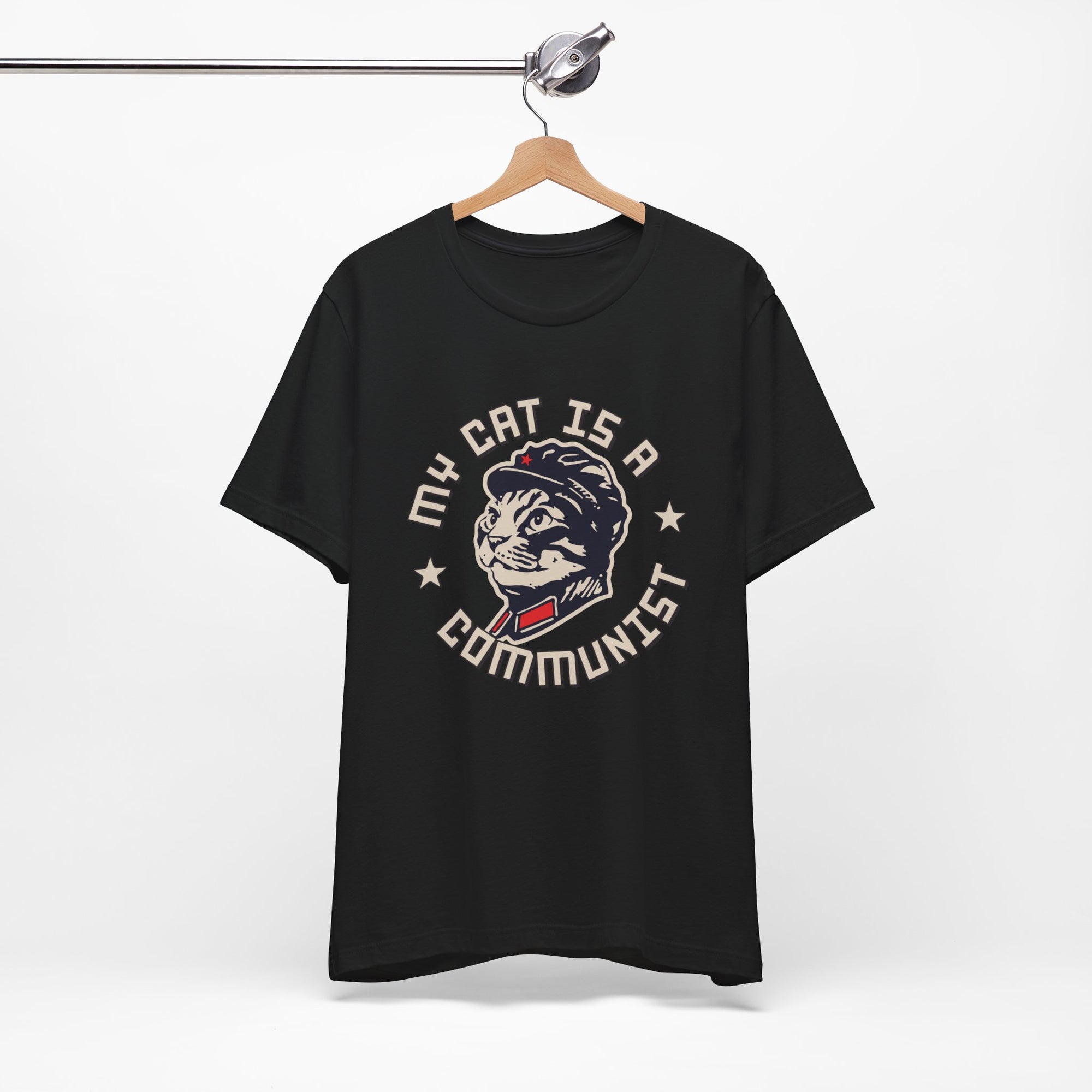 Black t-shirt with a graphic design of a cat and text on a hanger against a white background