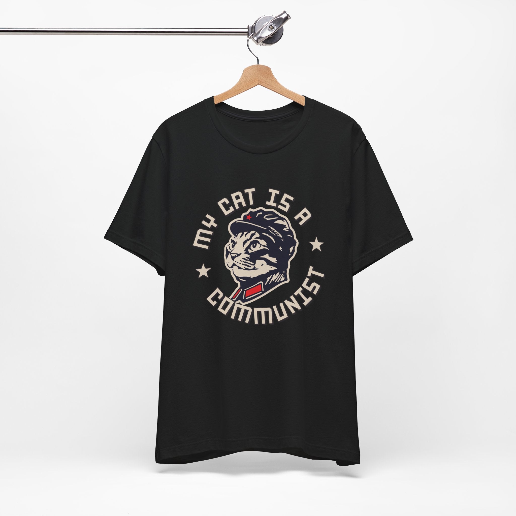 Black t-shirt with a graphic design of a cat and text on a hanger against a white background