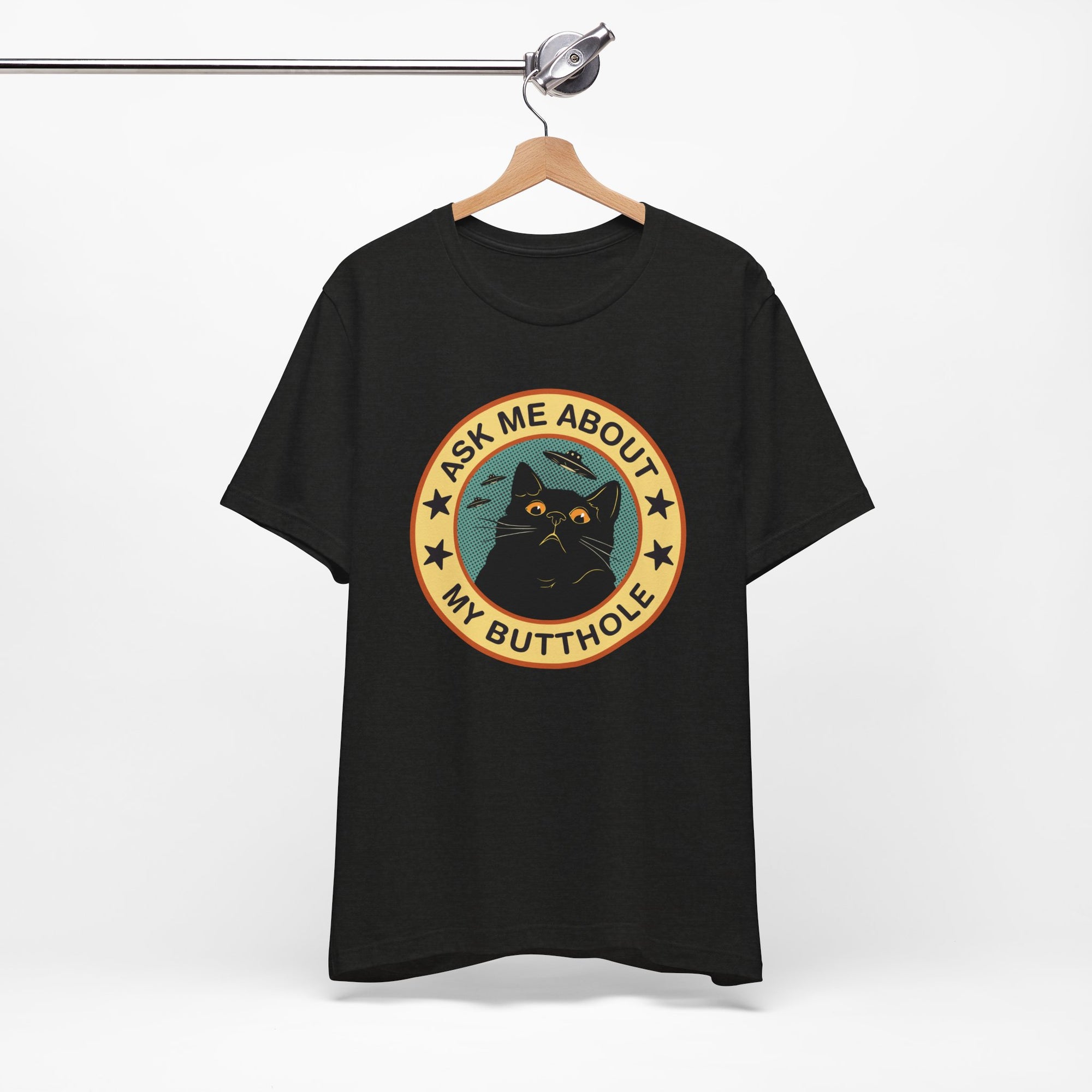 Black t-shirt with a graphic design of a cat and text on a hanger against a white background