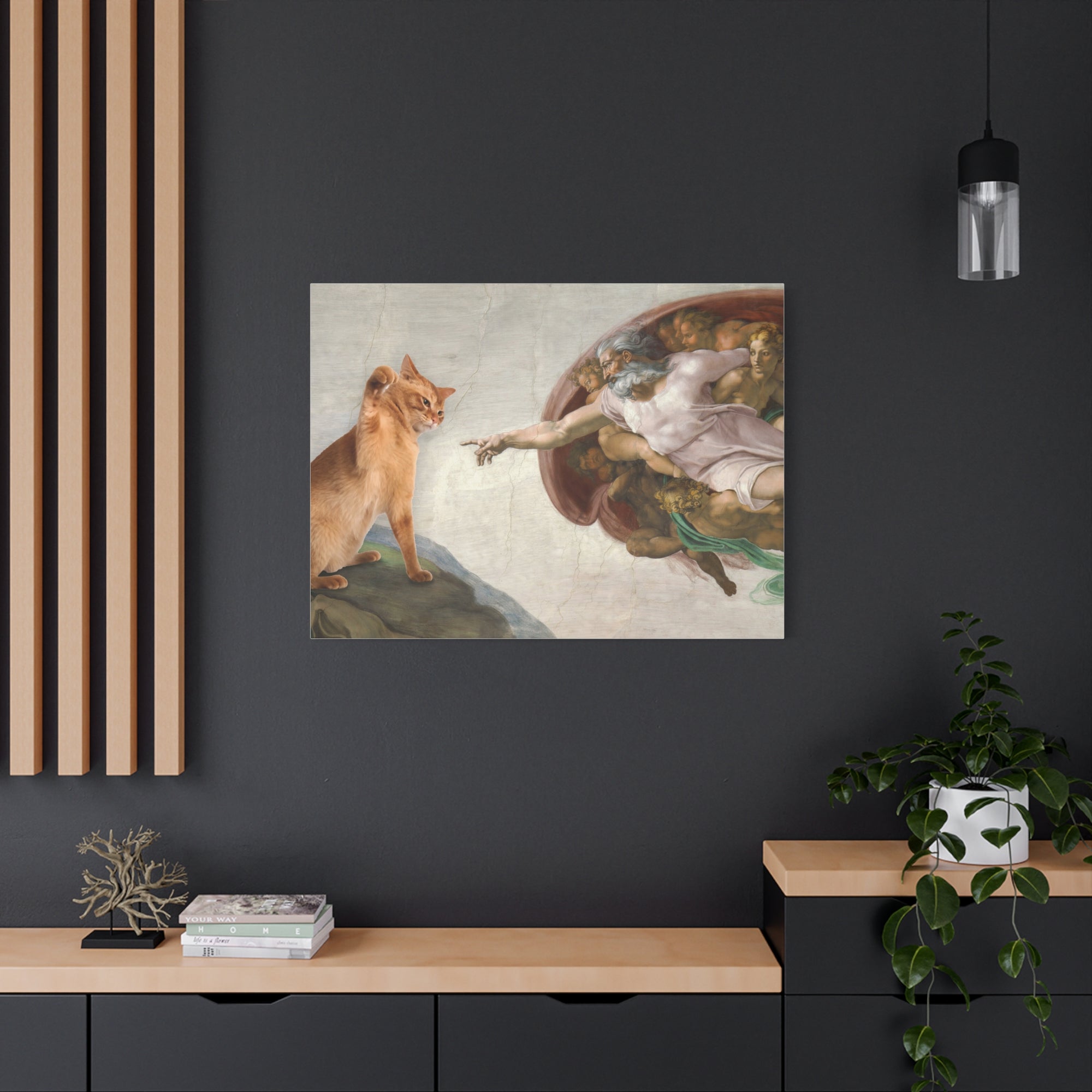 Framed artwork of a cat and classical figure on a dark wall with wooden shelves.