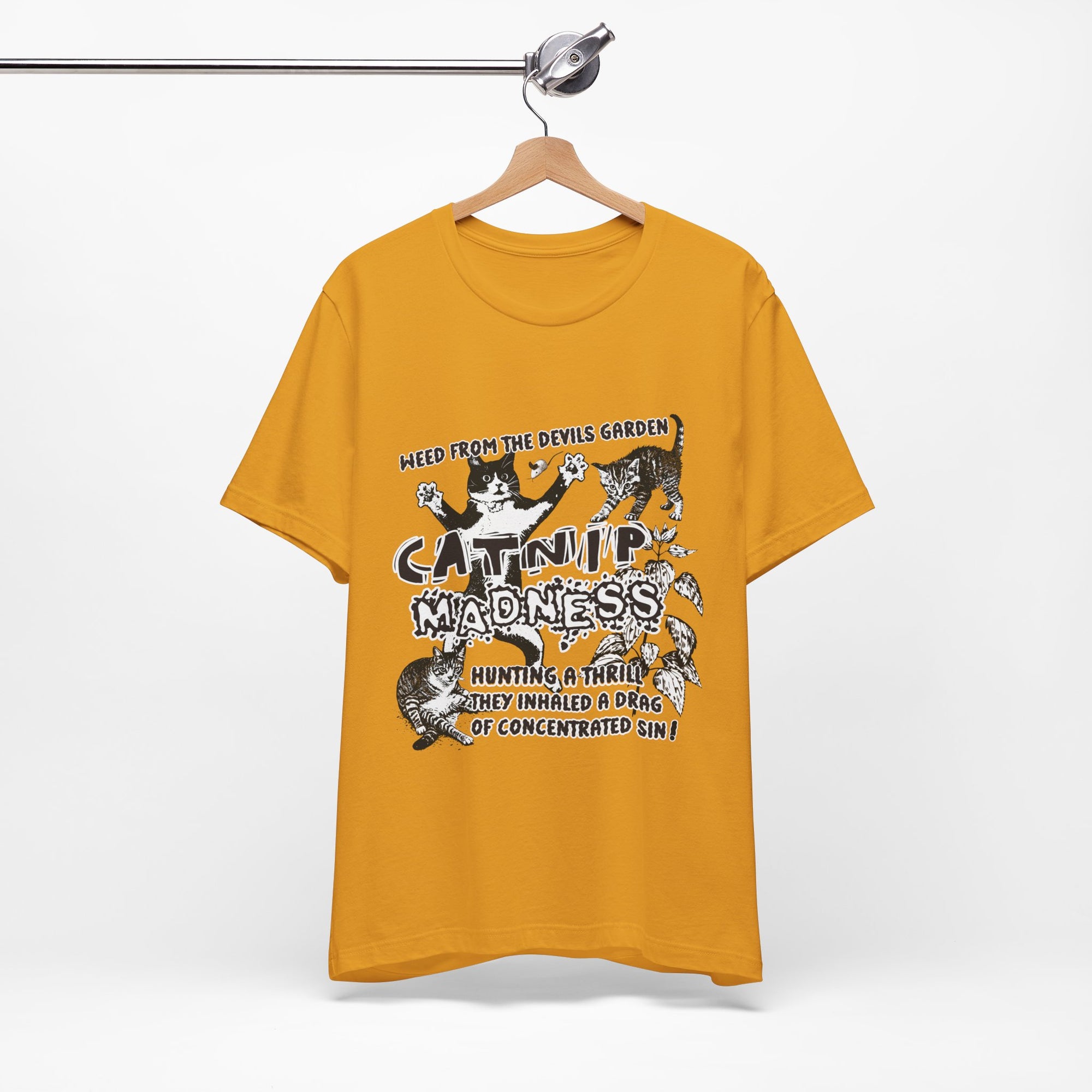 Yellow t-shirt with graphic design and text on a hanger against a white background