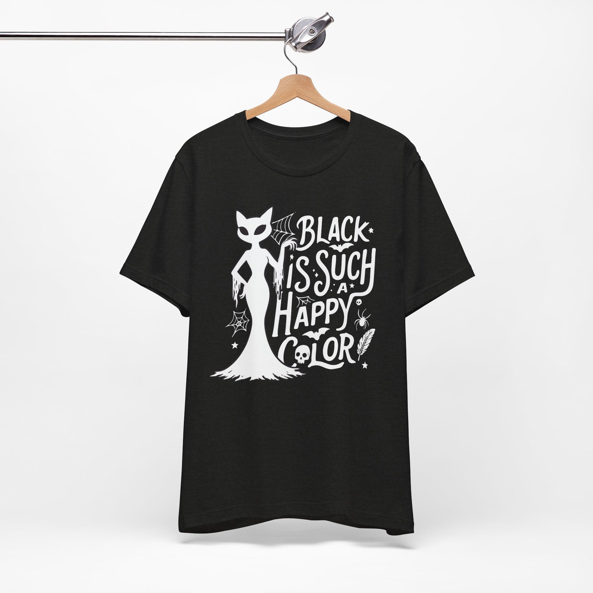 Black t-shirt featuring a white spooky cat graphic with the phrase “Black Is Such a Happy Color,” plus bats, spiderwebs, stars, and Halloween details.
