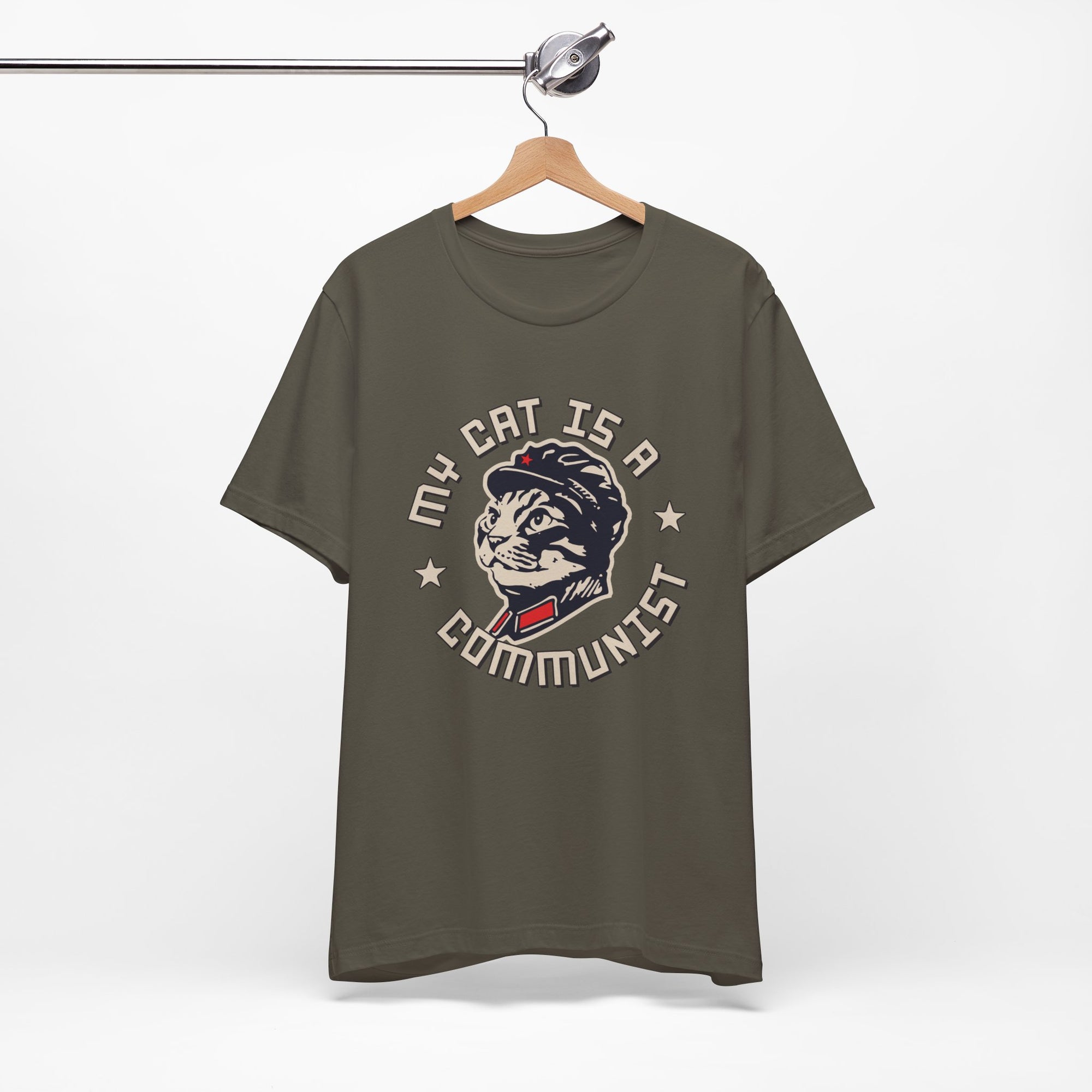 Green t-shirt with a graphic design of a cat and text on a hanger against a white background