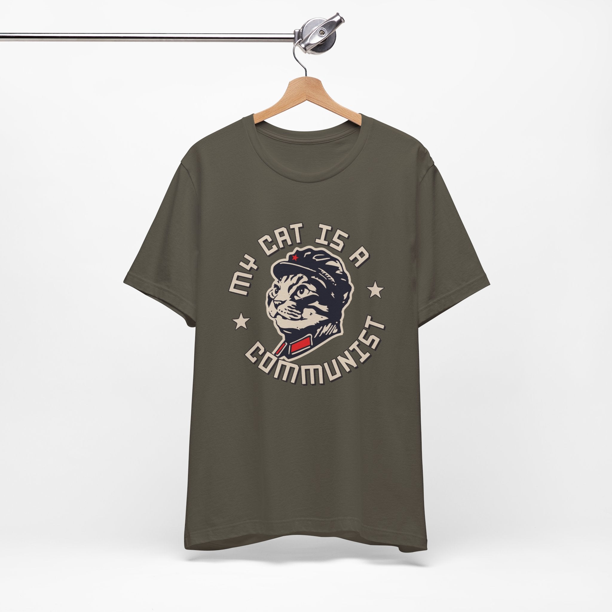 Green t-shirt with a graphic design of a cat and text on a hanger against a white background