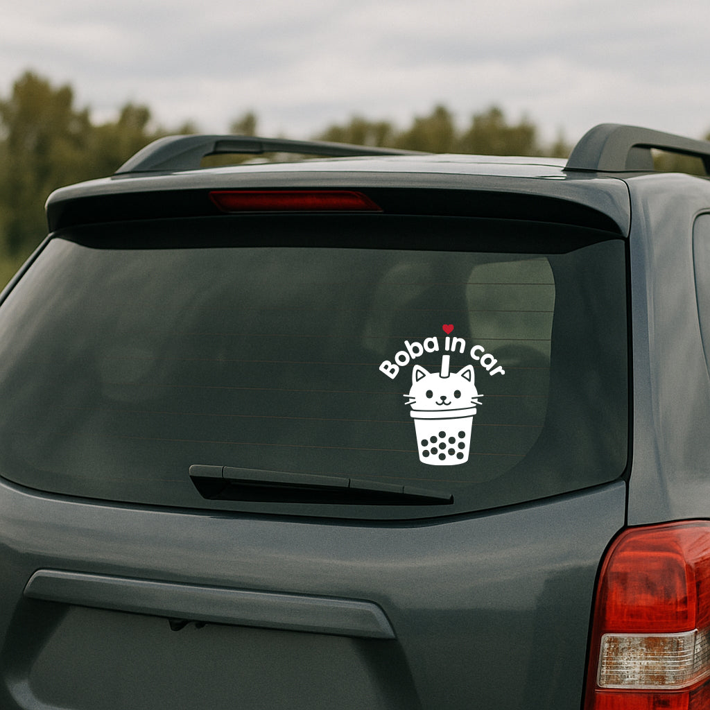 White vinyl decal on a car window featuring a cat-shaped boba cup with a straw, red heart, and curved text that says “Boba in Cat.”
