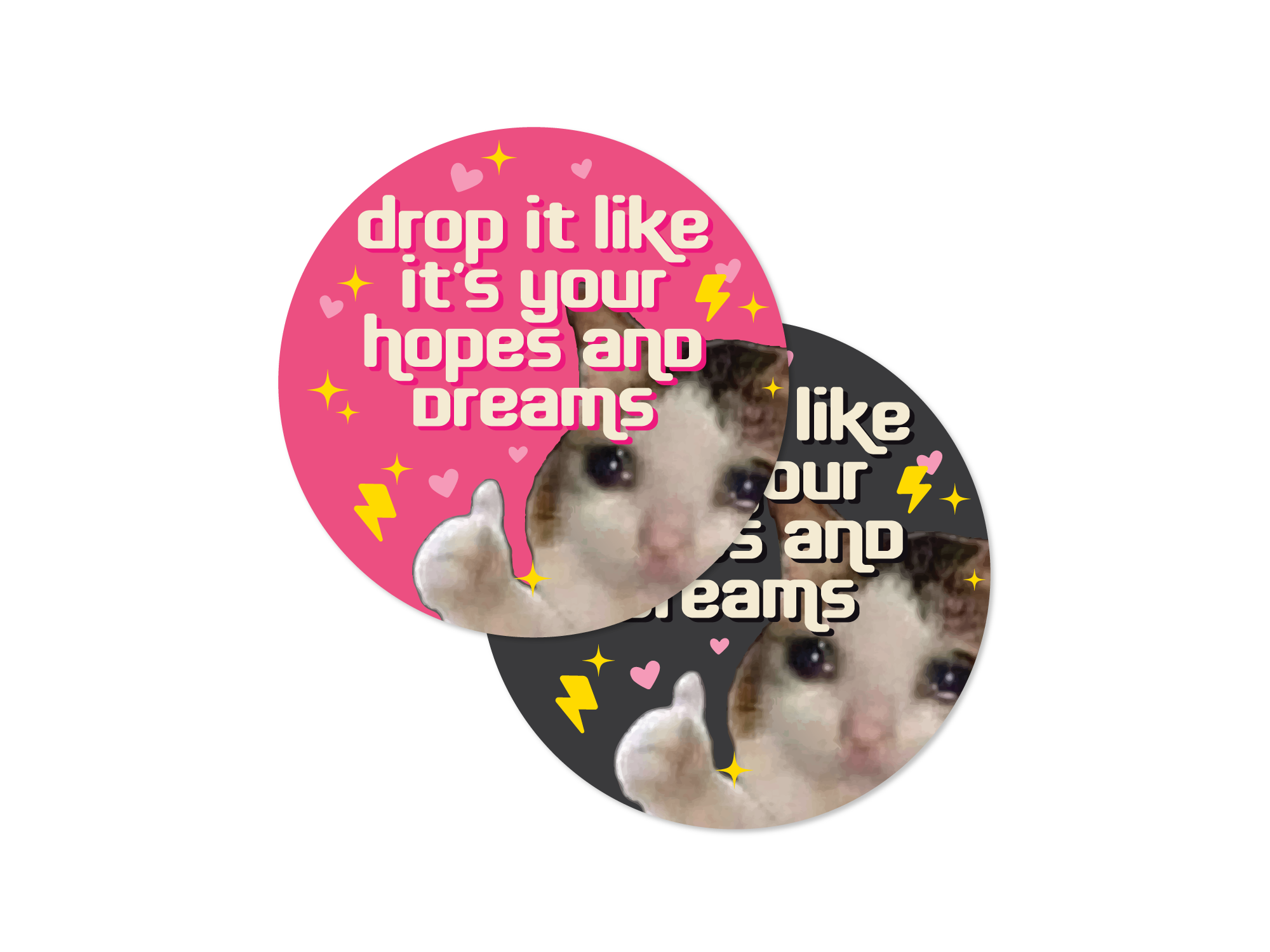Two round vinyl sticker options featuring a cat giving a thumbs up with hearts, sparkles, lightning bolts, and the phrase “drop it like it’s your hopes and dreams.”
