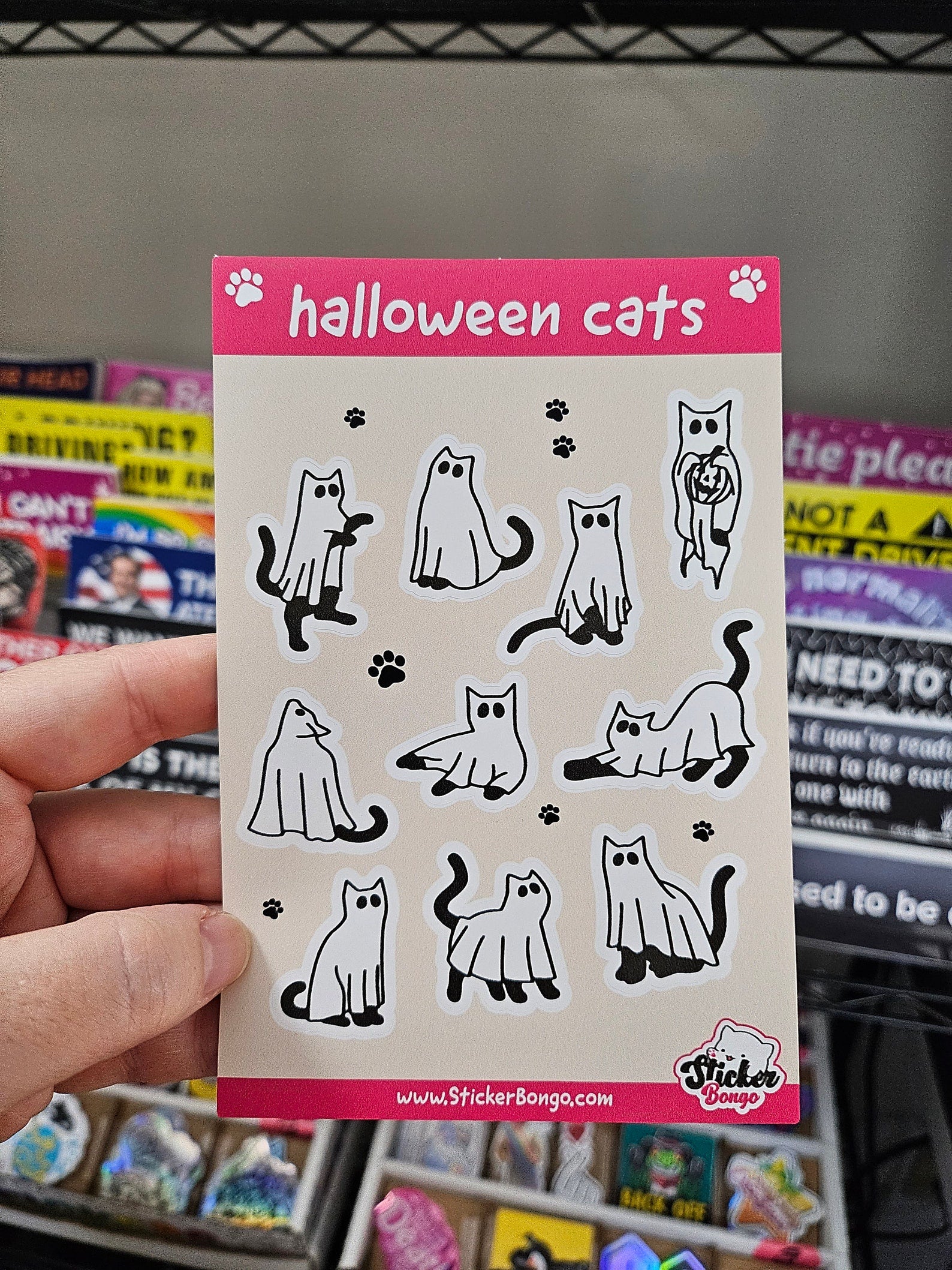 4x6 Halloween sticker sheet with 10 ghost cat vinyl stickers in different poses on a beige background with pink header and footer.