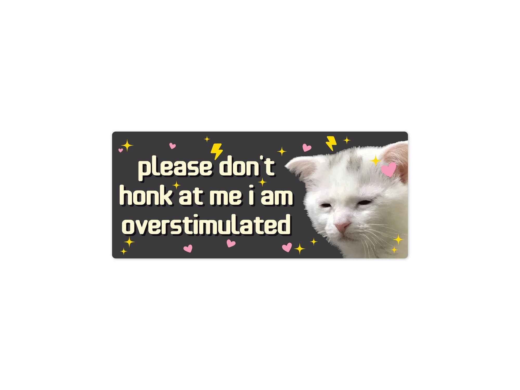 rectangular bumper stickers that say “please don’t honk at me i am overstimulated,” shown in pink and dark gray color options with a tired white cat, hearts, sparkles, and lightning bolts.
