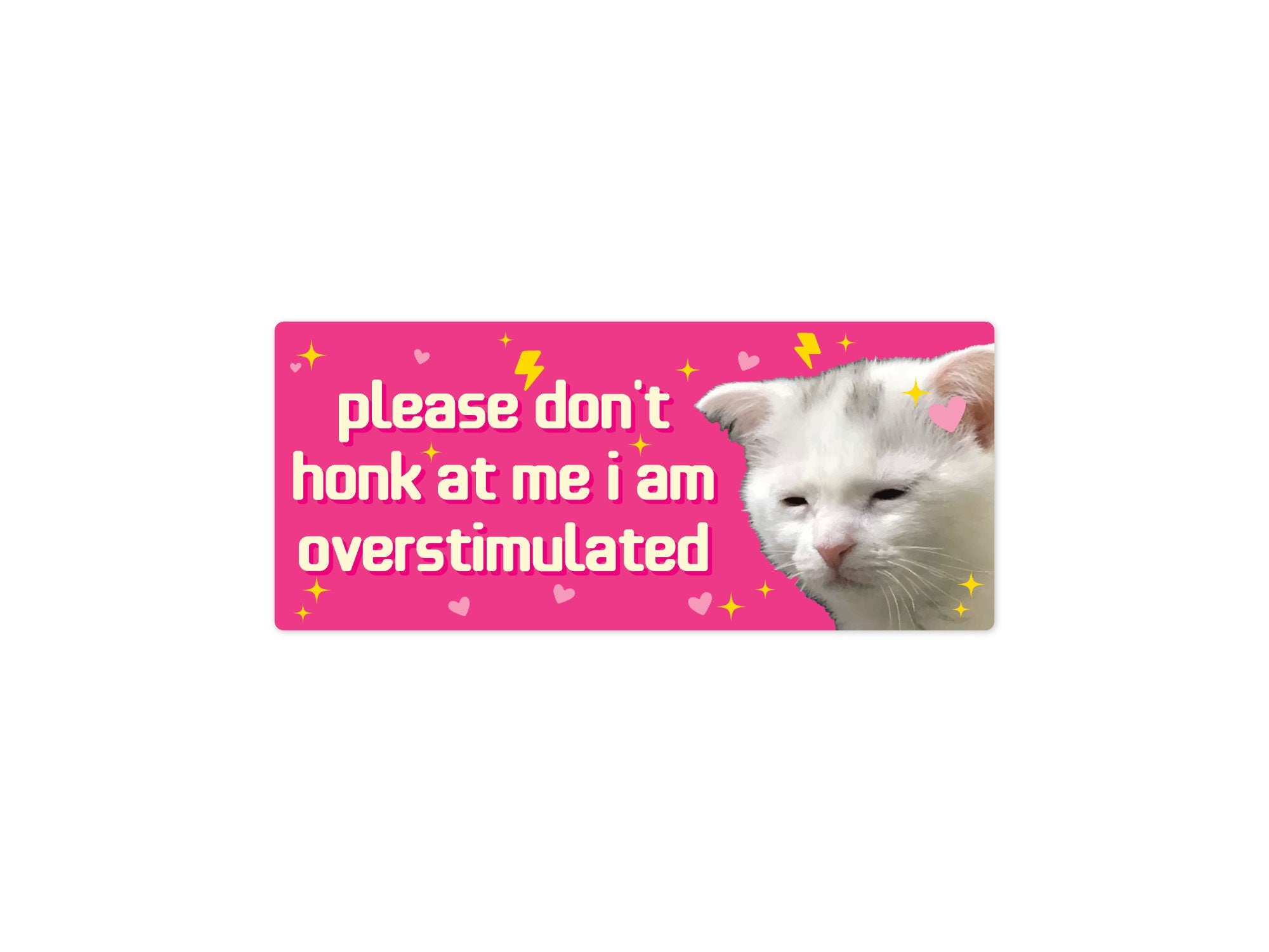 rectangular bumper stickers that say “please don’t honk at me i am overstimulated,” shown in pink and dark gray color options with a tired white cat, hearts, sparkles, and lightning bolts.
