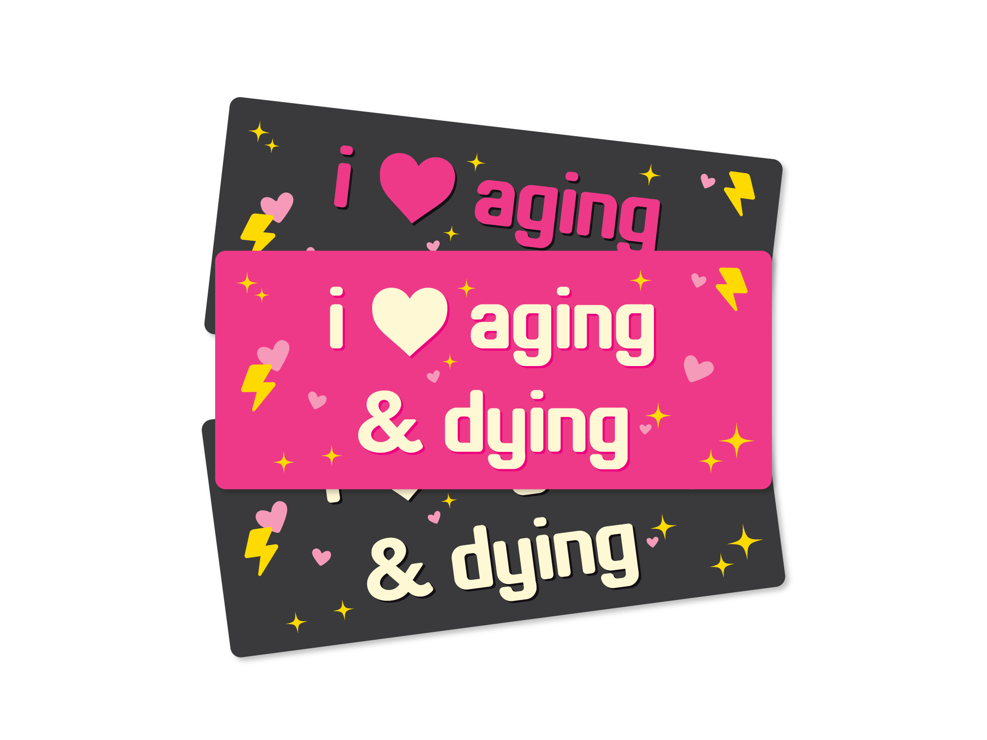 Three rectangular “I Love Aging & Dying” bumper stickers shown in pink and dark gray color options with hearts, sparkles, and lightning bolts.
