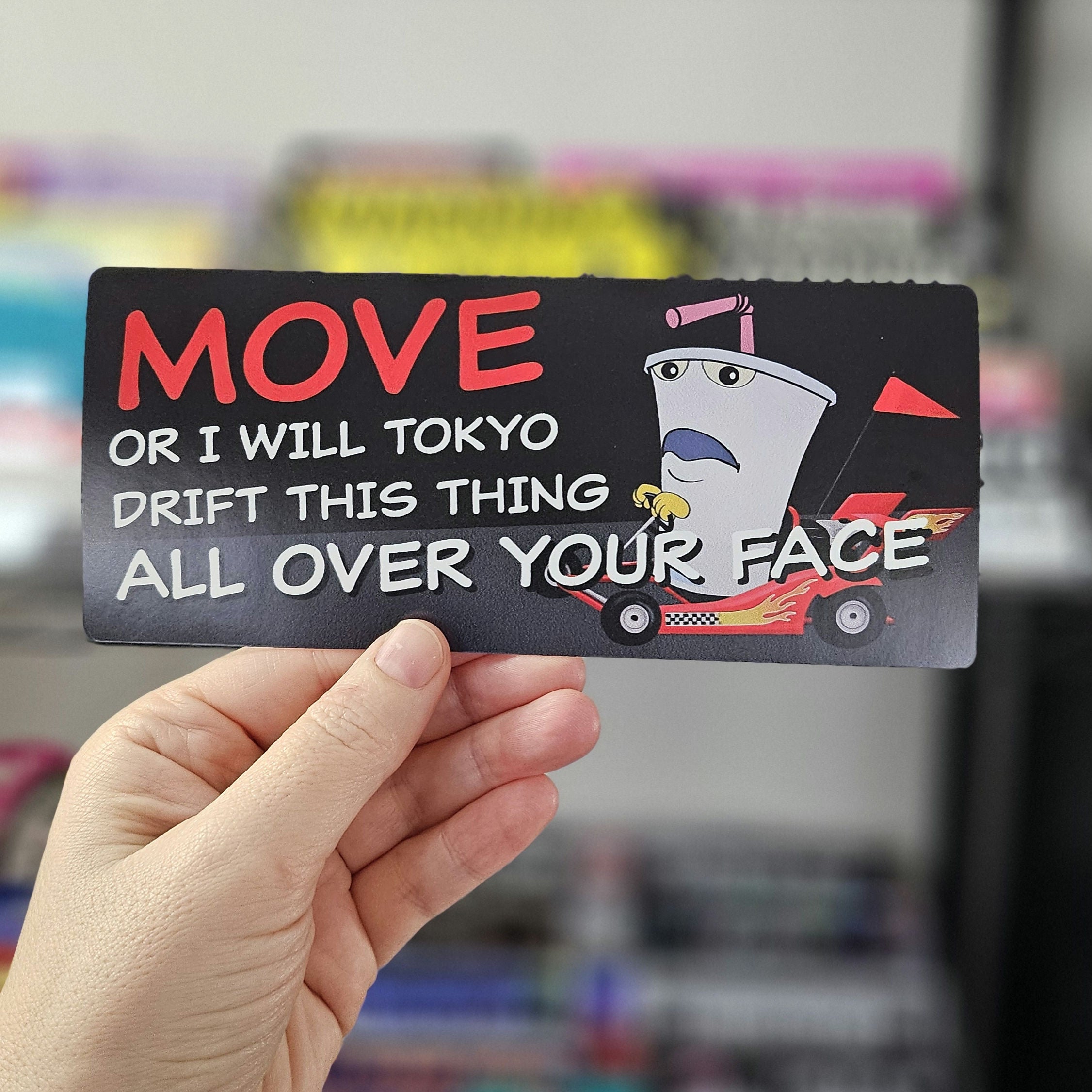 Rectangular bumper sticker featuring Master Shake driving a small drift car with the text “Move or I will Tokyo Drift this thing all over your face.”
