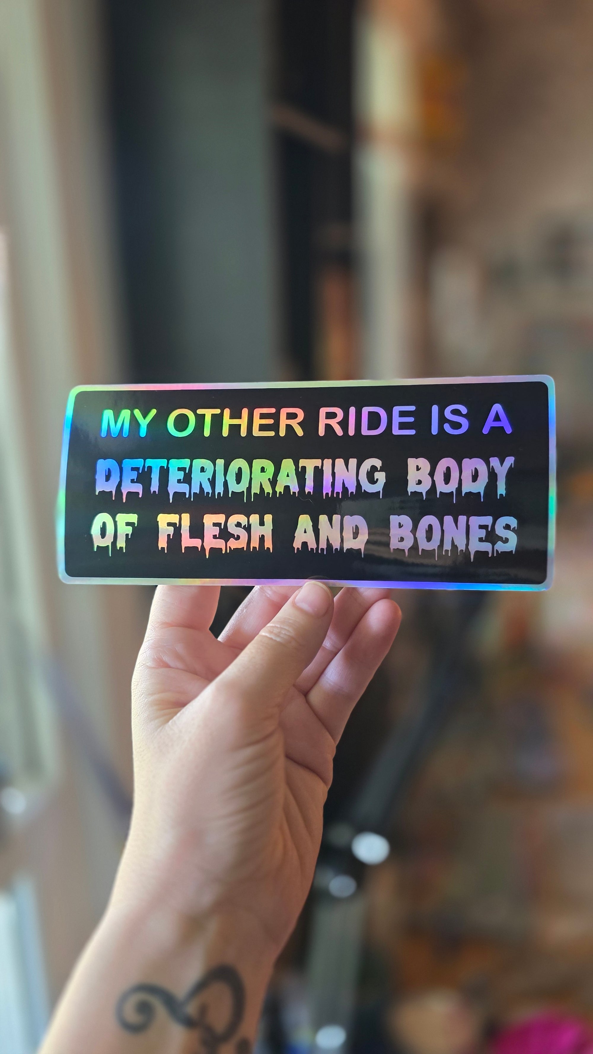 Hand holding a glowing rectangular device with text