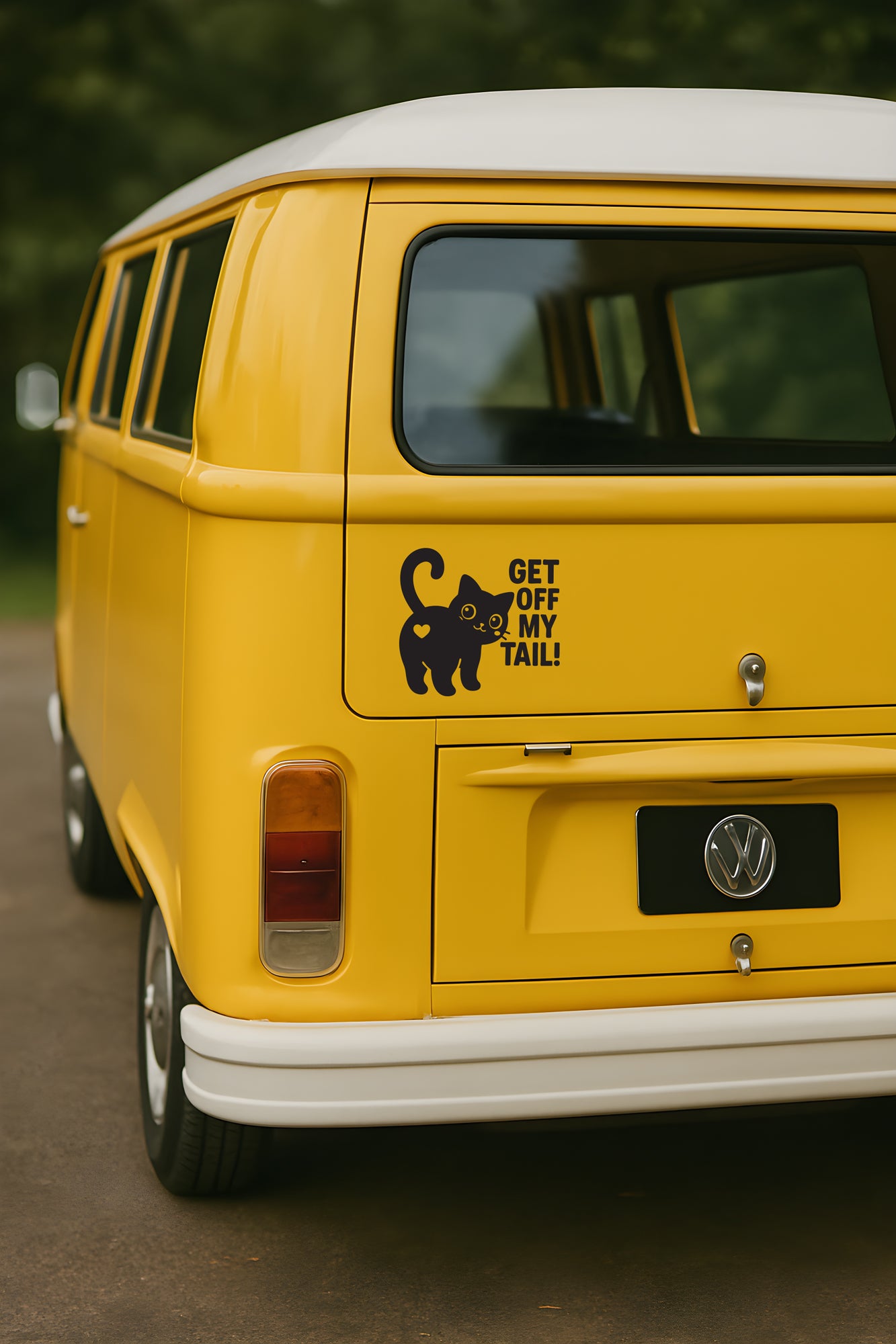 Black vinyl decal on a yellow bus featuring a cute cat with a raised tail and bold text that says “Get Off My Tail!”
